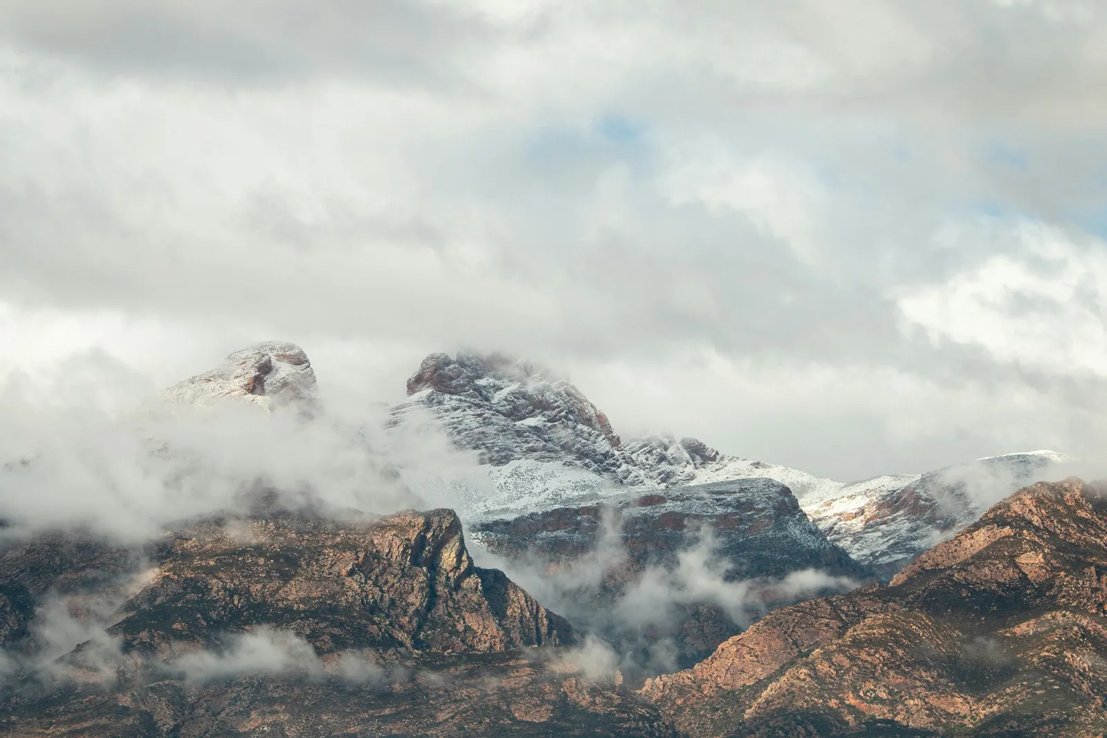 Snow on the mountain peaks above Ceres in the Western Cape, with cloud breaking over the ridges.